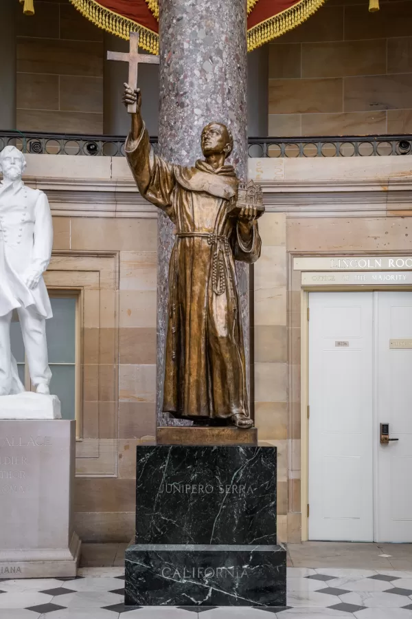 Bronze statue of a person standing.