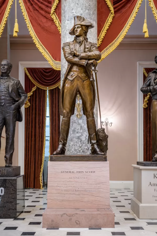 Bronze statue of a person standing.