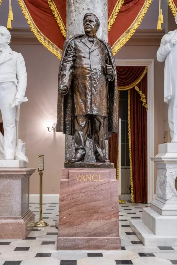 Bronze statue of a person standing.