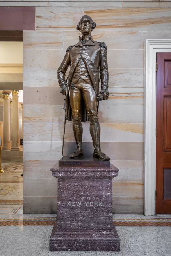 Bronze statue of a person standing.