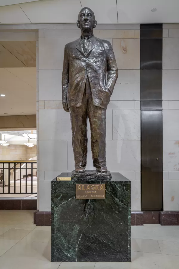 Bronze statue of a person standing.