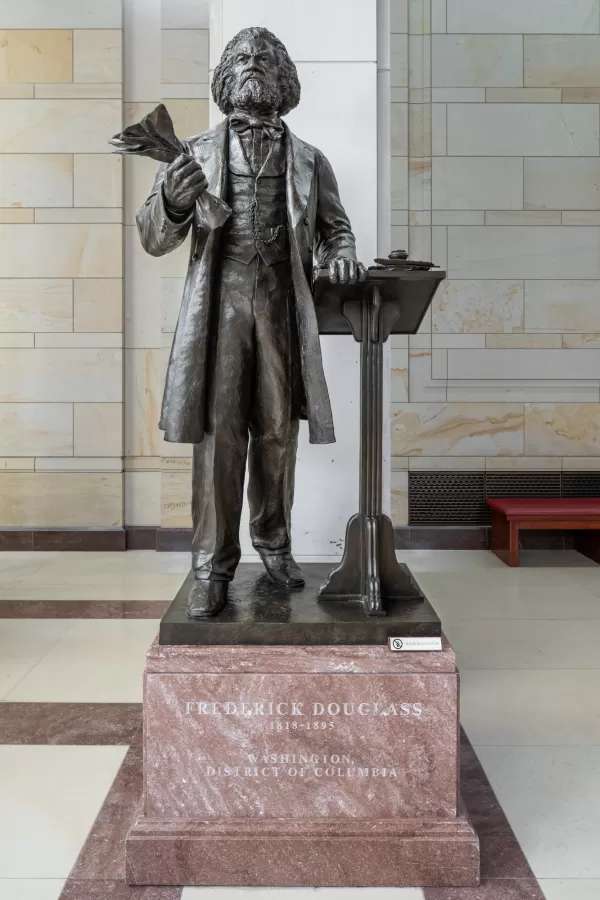 Bronze statue of a person standing.